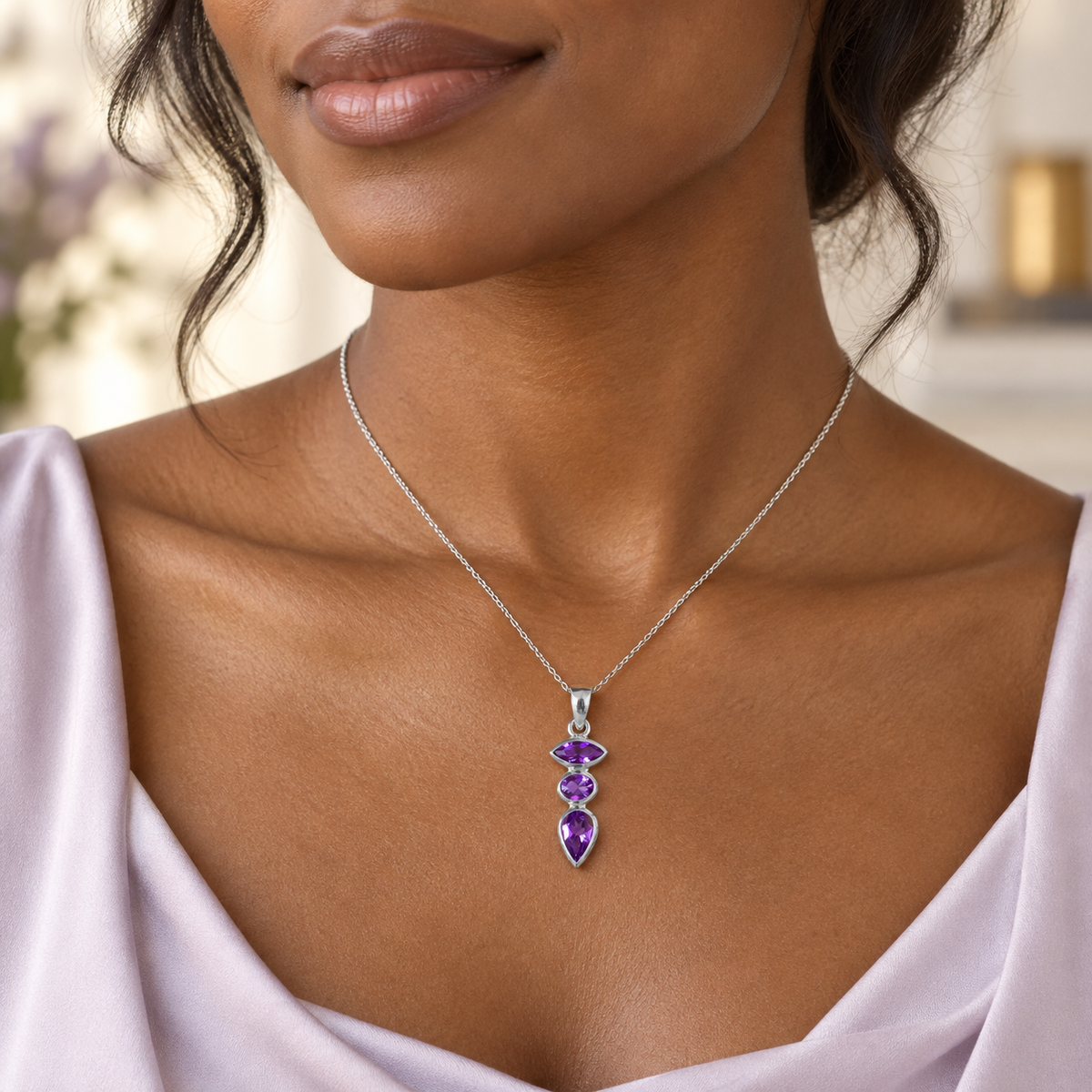 Poni Kahikolu purple gemstone pendant worn on a silver chain